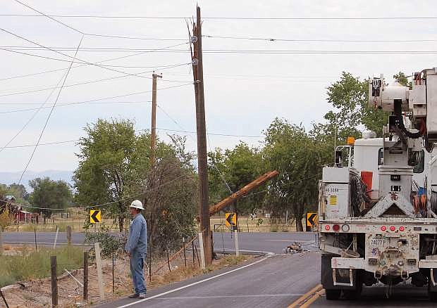 An NV Energy employee surveys the damage done when a big rig&#039;s equipment snagged the power liens and brought them down to the ground on Friday at Sheckler Road and Sheckler Cut-off.
