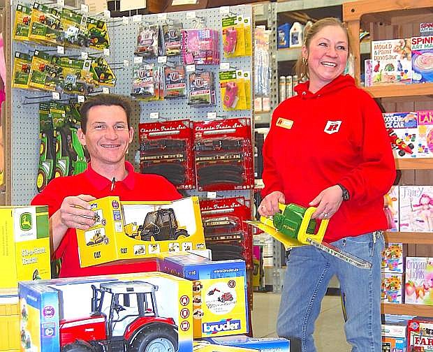 Big R assistant managers Beau Poutous left, and Martie Mothershead stack toys in preparation for Black Friday sales.