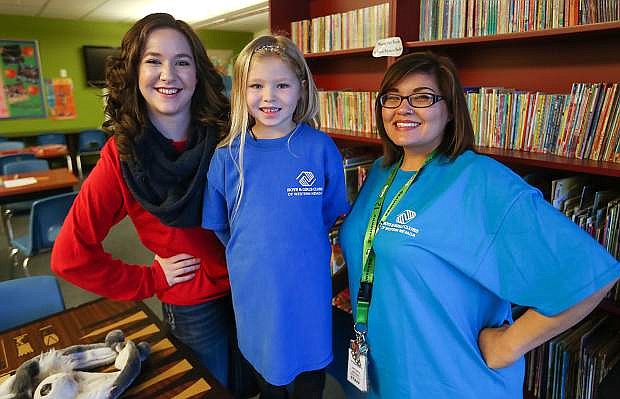 Staff members Alyson Christl and January Fierro pose with a member in the Learning Center at the Boys and Girls Clubs of Western Nevada in Carson City, Nev., on Friday, Jan. 23, 2016.