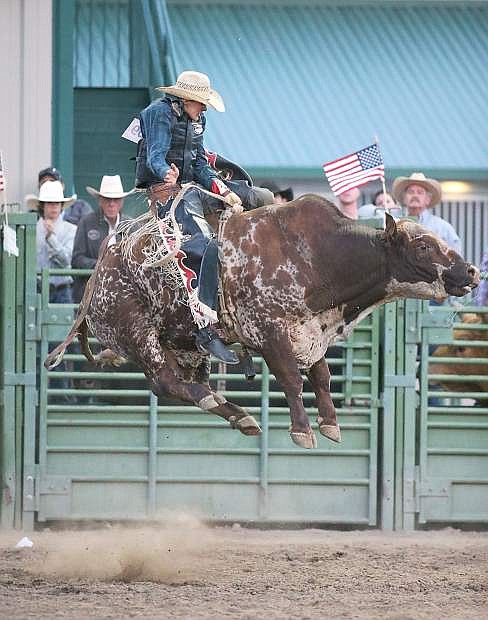 Dalton McMurtrie competes in the bull riding event at the Smackdown Tour at Fuji Park in Carson City, Nev., on Saturday, June 7, 2014.