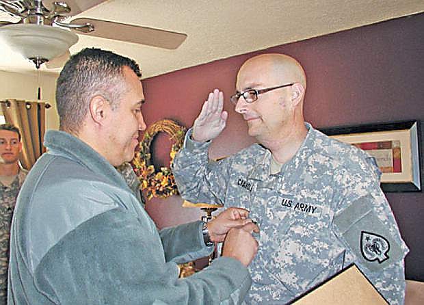 From right, James Chandler, Nevada Army National Guard combat engineer with the 609th, is promoted to captain by Lt. Col. Wilson de Silva of the 17th Sustainment Brigade Nevada Army National Guard.