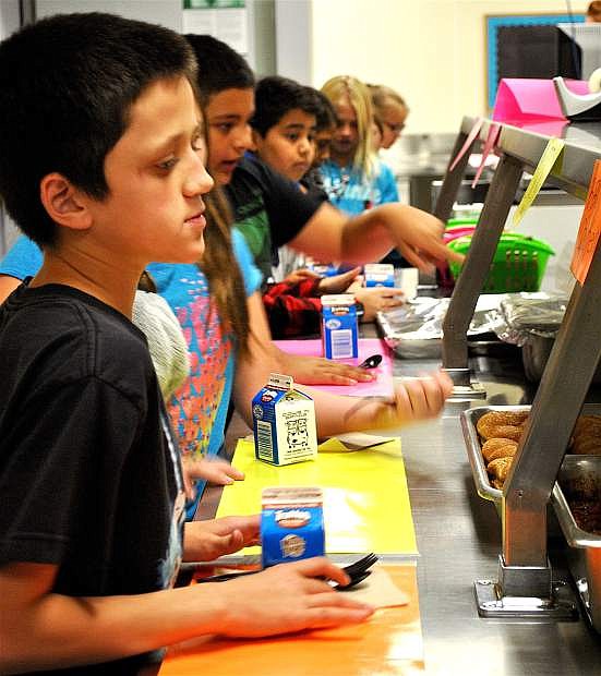 Numa Elementary fourth-graders including Jonathan Sullivan, front, make their way down the revitalized lunch line due to new meal service provider Chartwells.