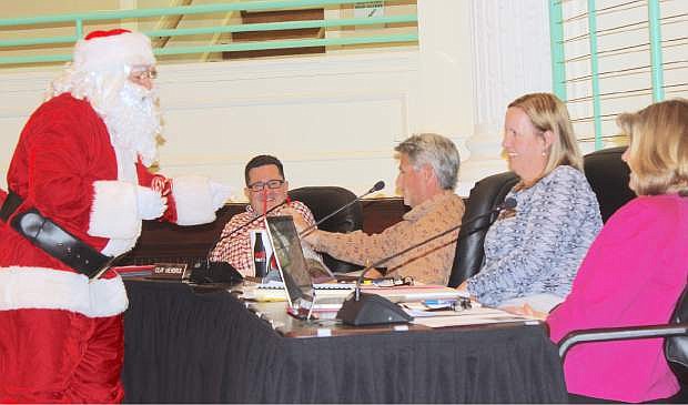 Santa Claus made a surprise visit at Thursday&#039;s school board meeting to pass out candy canes to, from leftt, Greg Koenig, Clay Hendrix, Phyllys Dowd and Sharla Hales