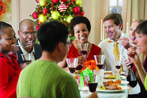 Friends enjoy a  dinner together with plans to celebrate the holidays.