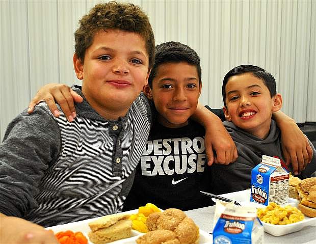 From left, fourth-graders Isaiah White, Alejandro Chavira and Kekoa Ninoa enjoy eating lunch together in the Numa Elementary cafeteria. &quot;It&#039;s the best food ever!&quot; White said.