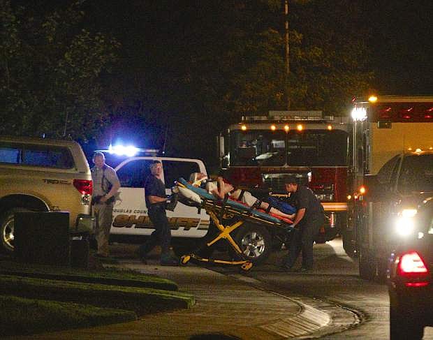 A person is wheeled out of the house on Edlesborough Circle Tuesday night in Gardnerville after a standoff ended peacefully.