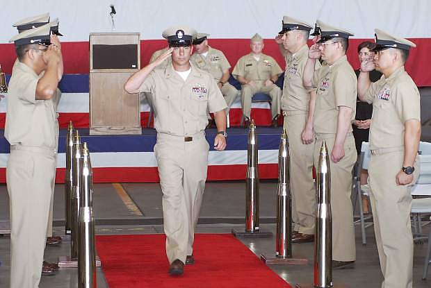 AGC Rocky McMahan walks through the side boys during a pinning ceremony.