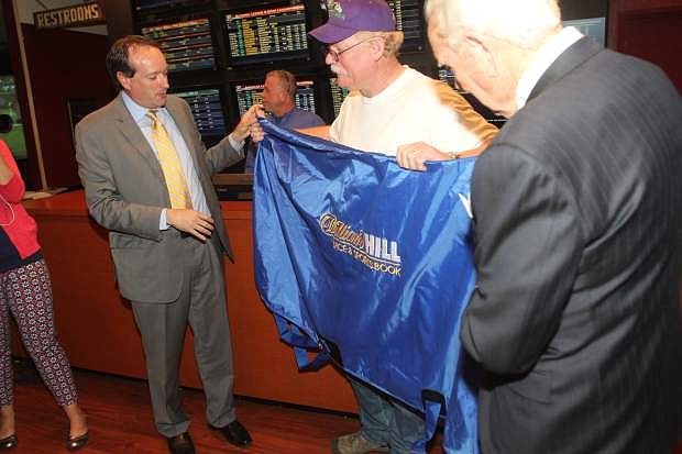Steve Coburn is presented with a blanket for California Chrome from  William Hill Sportsbook CEO Joe Asher, left, and Sharkey&#039;s Casino owner Hal Holder on May 28 at Sharkey&#039;s Casino in Gardnerville.