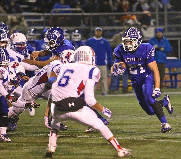 Carson running back Colby Brown (21) runs one up the gut in a win over Reno Friday night at CHS.