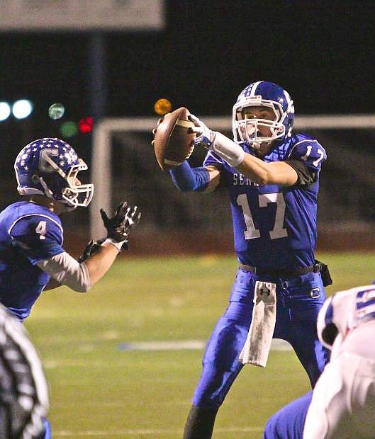 Senator quarterback Joe Nelson (17) takes a snap late in the game in a win over the Reno Huskies Friday night.