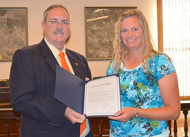Mayor Ken Tedford Jr. commends Anna Wadsworth for organizing a community clothing drive every summer that benefits more than 500 people.