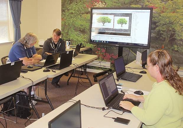 Instructor Lee  Stokes works with students Grey Bynum and Sara Dowling, right, in one of the summer&#039;s technology classes offered in a partnership with the Churchill County Library, Western Nevada College and the Churchill Economic Development Authority.