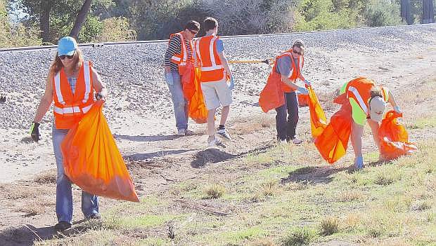 TOP IMAGE: Volunteers and employees from Financial Horizons Credit Union in Fallon spend Saturday morning by picking up trash along the Reno Highway.