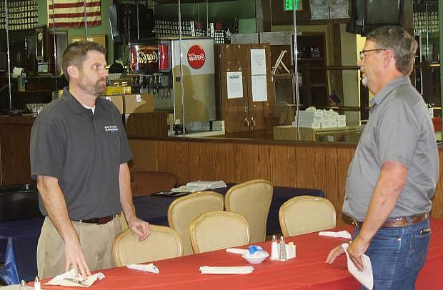 County commision candidate Carl Erquiaga, right, and Mark Feest discuss an issue after Erquiaga spoke to the Churchill County Central Republican Committee during lunch on Wednesday.