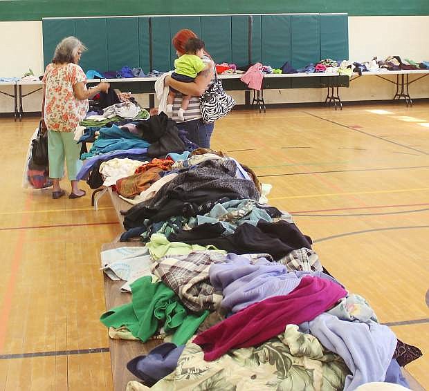 Two women sort through clothes at a previous Fallon Community Days.