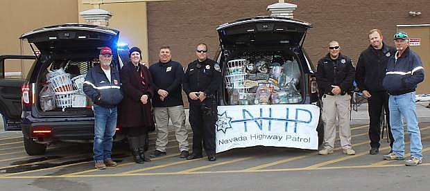 Cramming the Cruiser on Wednesday in front of Walmart are, from left, Jim Saling, fire department; Jamie Lee, Churchill County Senior Center; Nevada Highway Patrol Troopers Trent Barnes, Tony Bake, Mark Fox and James Farmer; and Ralph Hamman, chief, fire department.