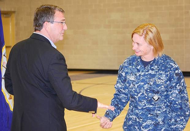Deputy Secretary of Defense Ashton Carter presents a coin to ADAN Adriana Makerney during his visit to Naval Air Station Fallon on Tuesday.