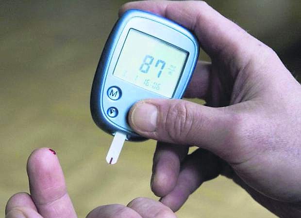 File photo shows a person with diabetes testing his blood sugar level.