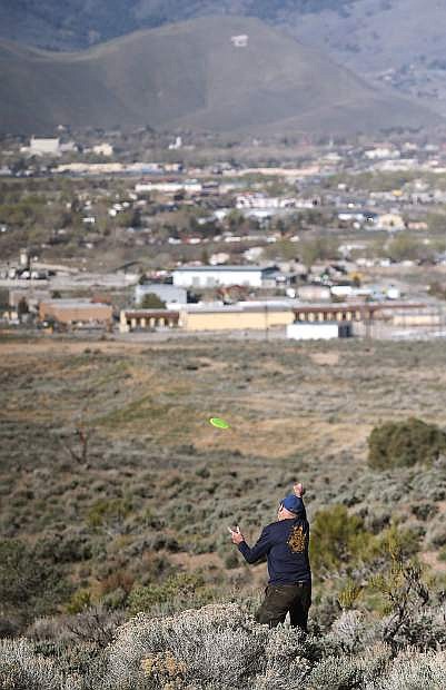 Organizer Gregg Swift demonstrates disc golf on a proposed course east of Carson City, Nev., on Wednesday, April 6, 2016.
