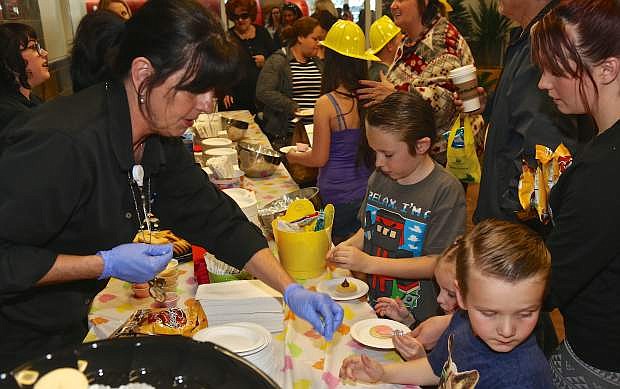 Marianne Seals helps kids decorate cookies Wednesday at Carson Tahoe&#039;s Eggstravaganza.