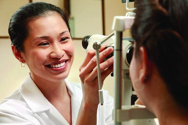 An optician examines a  patient&#039;s vision.