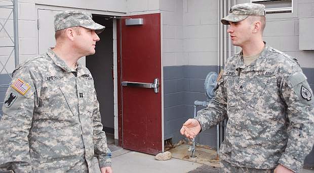 Capt. Joannes Lamprecht, left, the new commander of the 609th Combat Engineer Co., listens to one of his soldres, Staff Sgt. xxxxxxxxx