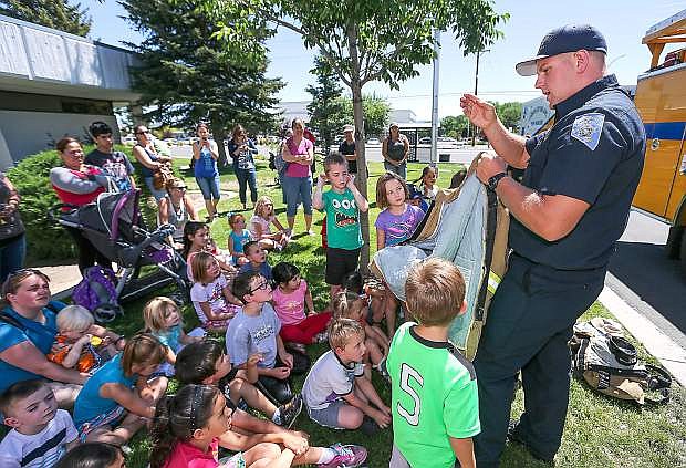 Carson City Firefighter/Paramedic Matt Cooper talks to a group of children during Storytime at the Carson City Library in Carson City, Nev. on Thursday, June 18, 2015. The event was part of the Summer Reading Program &quot;Every Hero Has A Story&quot; series. For more information about upcoming events, go to www.carsoncitylibrary.org.