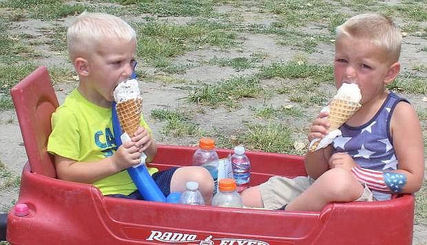 Bryon, 2, left, and Curtis Hammack, 4, enjoy their ice cream cones during family fun festivities at the Churchill County Fairgrounds on the Fourth of July. Hundreds of residents came out to the fairgrounds after the parade to listen to music, play games and have lunch. The Best Automobile Group during the parade, the Antique Car Cub, chug along the parade route Saturday morning. For more photos, go to pages 12-13 or to the LVN Facebook page.