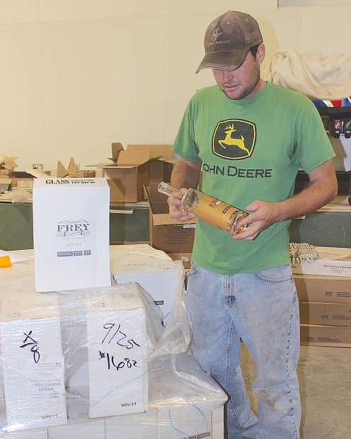 Colby Frey shows cartons of bottles that arrived at the distillery several weeks.