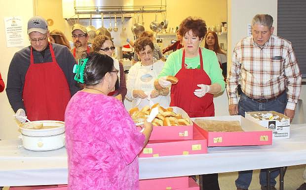 From left, Calvin Johnson, Bonnie Bell, Marlene Caffrey, Noni Allegre and Dan Alegre volunteered with many others to prepare and serve dinner on Christmas Eve at the Wolf Center. Stefani Hanks organized the community event, and members of the Fallon Churchill Fire Department cooked the turkeys, while other volunteers made side dishes.