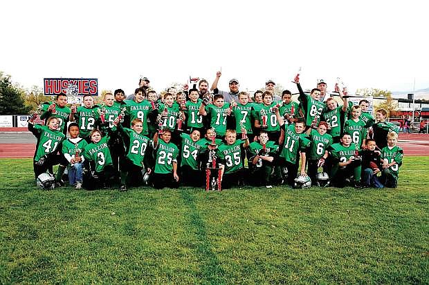 In this file photo from Catherine Steelmon. members of the FYFL freshman football team celebrate with their championship trophies after defeating Fernley in 2009 at Reno High.  Pictured bottom row, from left are Blake Bradley, Ryan Bitter, Preston Steele, Wyatt Getto, Cord Hendrix, Kobe Abe, Aaron Bitter, Cameron Matzen, Sean Rigsby, Kyle Larsen, Jarod Harmon, Gabe Cooper, Brock Richardson and Tommy McCormick. Middle row, from left, Evan Bitter, Trae Workman, Sam Goings, Alex Mandez, Chase McElvain, Lane Giovanetti, Brady Stiehl, Cameron Beyer, Connor Richardson, Calvin Greenwell, Brandon Beeghly, Riley Williams, Sean Cordes, Taylen Cordes, Nolin Rusk, Clayton Davison, Johnny Mayo, Sean McCormick, Will Bliss, Jayce Harmon. Top row, from left, coach Steve Moon, Robert Hurlburt, coach Greg Moon, head coach Sean Richardson, coach Randy Beeghly,  coach Ed Workman.