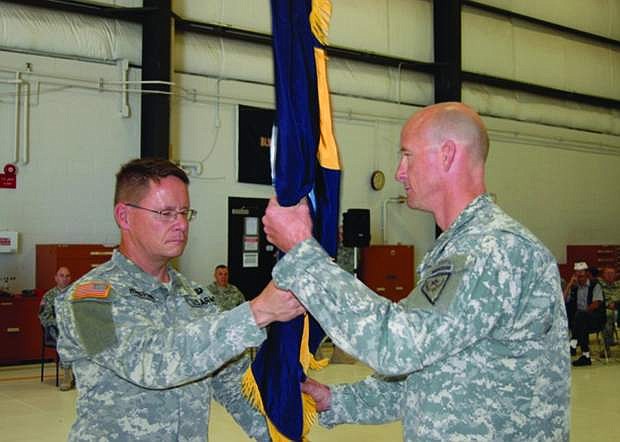 Col. Dan Waters, right, receives the colors of the 991st Troop Command from Army Guard deputy commander Col. Mike Hanifan on July 14 in Reno. Hanifan, who grew up in Fallon, will have his own change of command on Sept. 7 when he becomes the state&#039;s new Commander Army Guard.