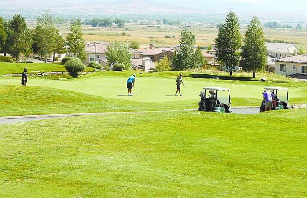 Golfers putt at Genoa Lakes Golf Resort in 2012..