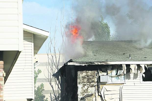Flames shoot from the roof of an apartment building in Gardnerville on Tuesday evening.