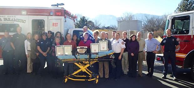Members of the Douglas Healthcare Coalition pose with a 12-lead cardiac monitor, a proclamation from Gov. Brian Sandoval for East Fork Fire and Tahoe Douglas Fire along with the Heart Safe Community awards.