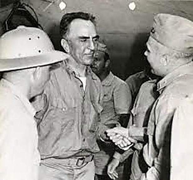 A wan Capt. Eddie Rickenbacker, center, who lost 54 pounds during his 24-days in a life raft, is shown as he is about to be flown from Samoa to New Guinea to meet Gen. Douglas MacArthur.