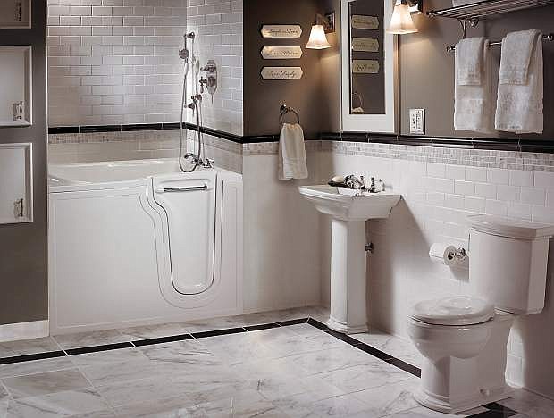 A walk-in tub, pedestal sink, and raised-height toilet are key bathroom safety features.