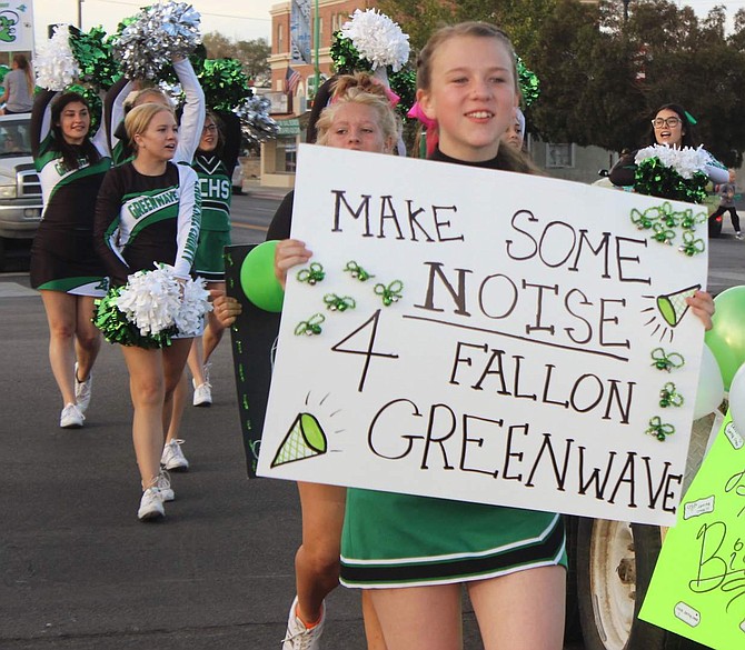CCHS cheerleader Kacee Santos holds up a sign before the parade to show her school spirit.
