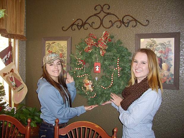 CCHS Seniors Nichole Mariezcurrena, left, and Hannah Isbister, helped Dee Dee Ferguson put the final touches on her home. The Christmas Home Tour takes placeSaturday from 3-8 p.m. at five homes across the county and benefits the 2016 Grad Nite Celebration.