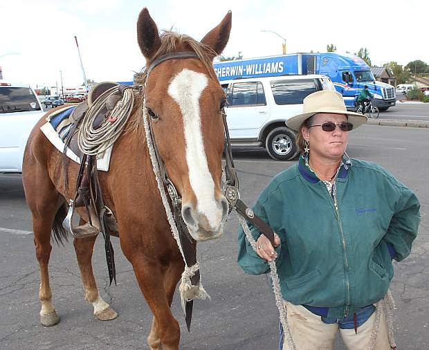 Colleen Rupp-Kness of Twin Falls, Idaho, exercises her horse durng a stop in Fallon. She and otehr riders met another teamof riders east of Lovelock later in the day.