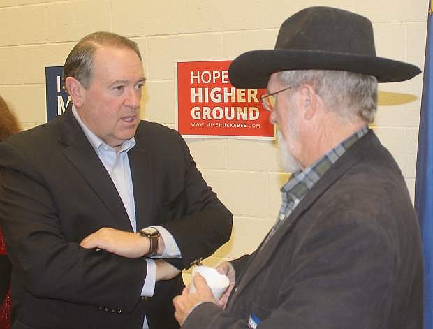 Presidential candidate Mike Huckabee, left, talks with Pastor Sam Stanton of Fallon.