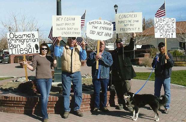 Fallon Tea Party memebrs protested President Barack Obama&#039;s executive action that granted amnesty to about 5 million undocumented aliens. Fromleft are  Amber Sanchez, Jim Falk, Rupert Wyble, Ed Martinez and Rick Sanchez.  The dog is named Sadie.