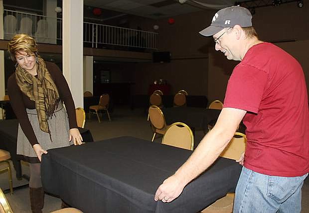 Natalie Parrish, left, executive director of the Fallon Chamber of Commerce, and Paul Herzbrun set up tables for Friday&#039;s job fair.