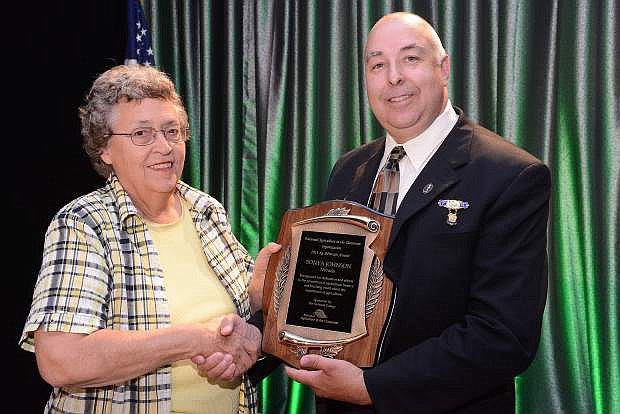 Sonya Johnson receives the 2013 National Ag Advocate Award from National Grange Executive Member Duane Scott during the National Ag in the Classroom Conference.