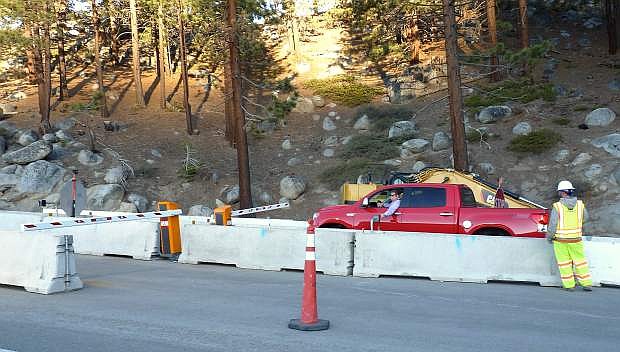 A motorist uses a pass to cross the barricade at the top of Kingsbury Grade on May 1, the first day Kingsbury Grade was closed for construction.