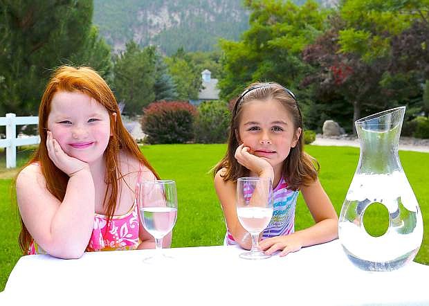 Lilianna Adamson and Katelyn Coons enjoy a pitcher of Genoa water, which was recently pronounced the tastiest in the state.