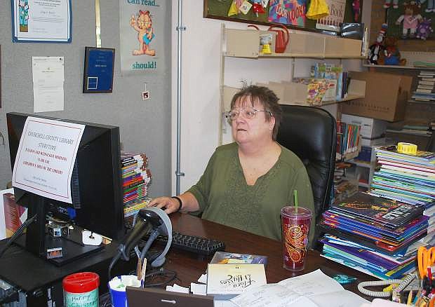 Children&#039;s librarian Joyce Betts works at her computer on a quiet afternoon.