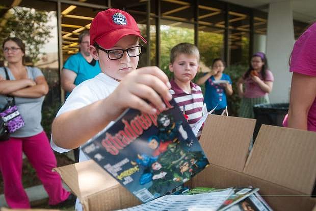 Caleb Showe, 10, looks for a comic book during the annual End of Summer Reading Program Party at the Carson City Library in Carson City, Nev., on Saturday, Aug. 8, 2015. This year&#039;s Summer Reading Program theme was focused around Community Heroes and featured local agencies like Carson City Fire, Sheriff&#039;s Department and the Nevada National Guard.