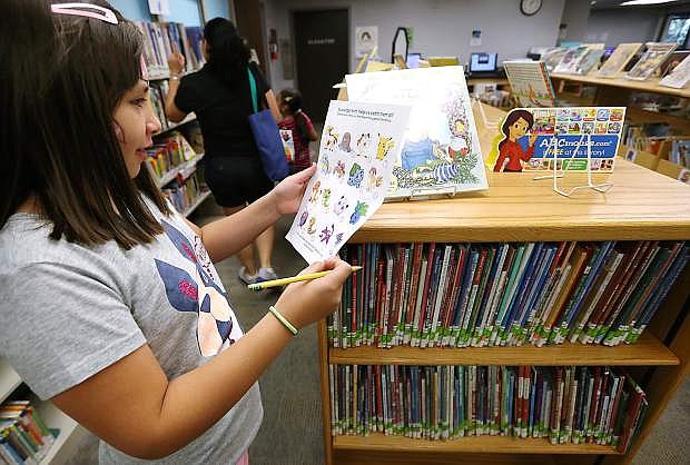 Emily Lozano, 10, completes a Scavenger Hunt during the end of the Summer Learning Challenge celebration at the Carson City Library, in Carson City, Nev., on Saturday, Aug. 20, 2016.