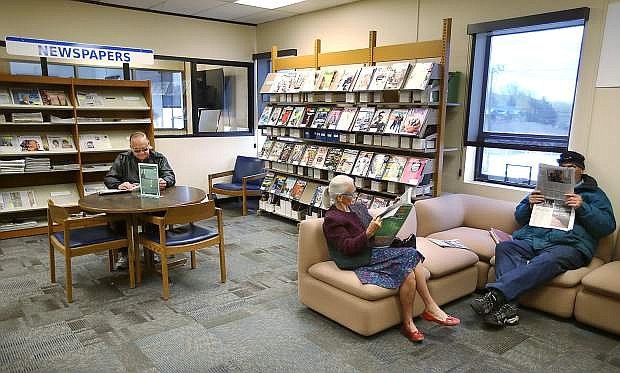 Patrons read newspapers and magazines at the Carson City Library in a file photo from April 2015. The library is looking for new donors to sponsor subscriptions to periodicals.